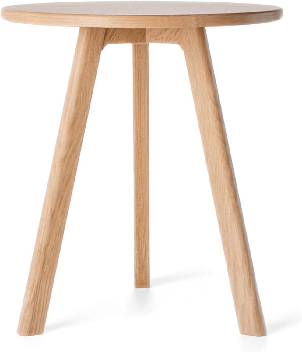 Raico natural-oak round side table beside a linen sofa