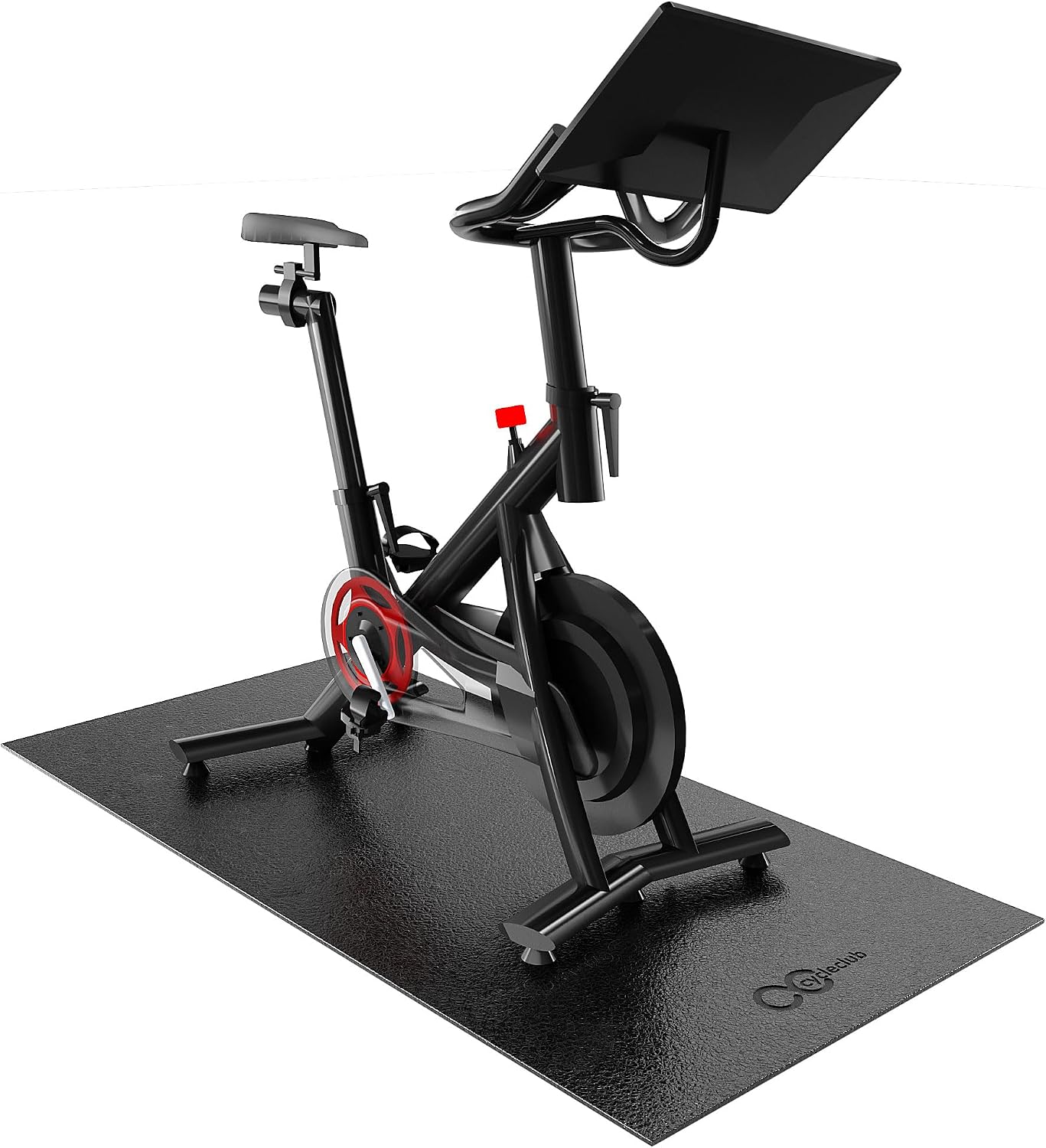 A triathlon bike on an indoor trainer over a compact black mat in a tidy apartment corner