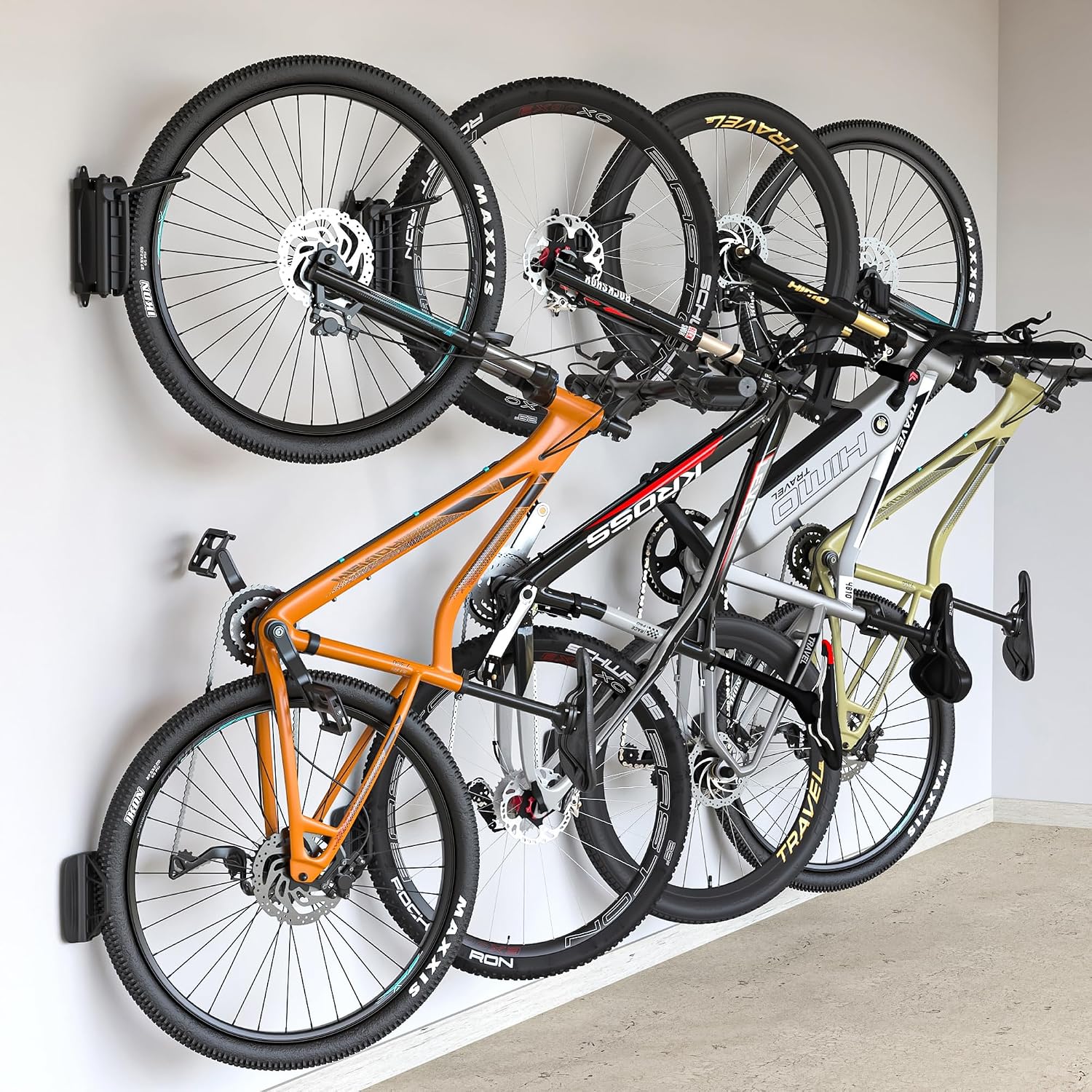 A bicycle on a swivelling vertical wall mount folded toward the wall in a narrow hallway