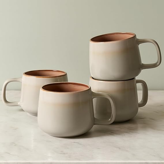 Four sage stoneware coffee mugs with matching shapes